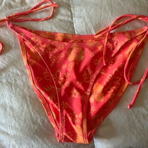 Kulani Kini full cover bottoms. Red orange and orange hibiscus flowered